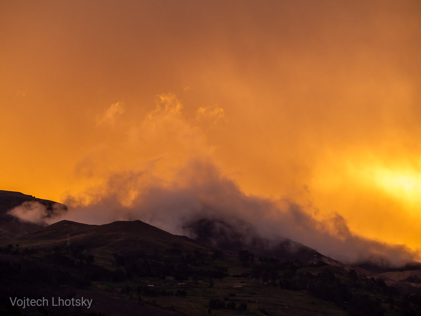 Západ slunce ozařuje mlhu nad pohořím Cordillera Negra